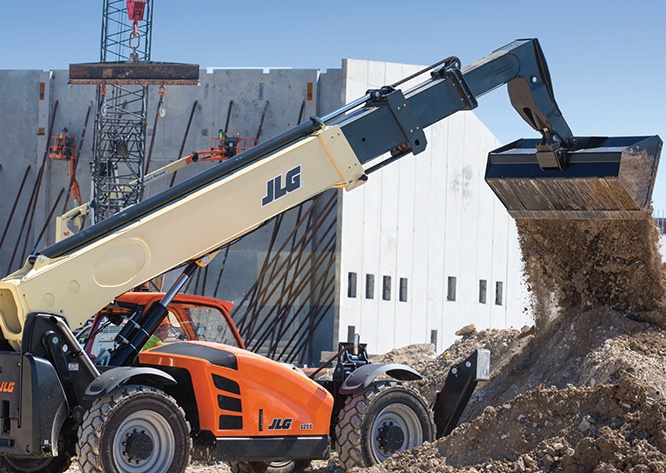 Telehandler dumping soil with bucket attachment